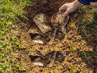 a pile of plastic in dirt