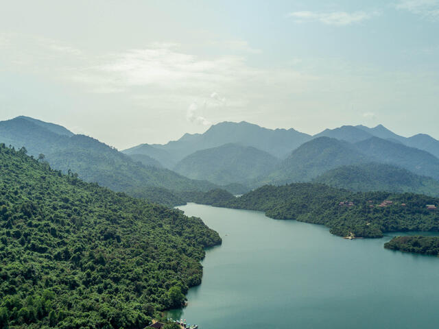 Hazy mountains with a lake between them