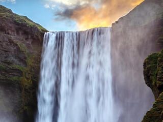 Green cliffs with a waterfall