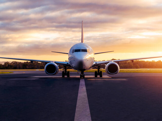 Sunset view of airplane on airport runway under dramatic sky in Hobart,Tasmania, Australia.