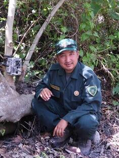 Dr. Tshering Tempa next to a camera trap