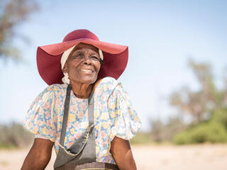 Rebecca Adams sits outside De Riet village, Namibia