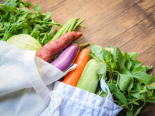 Vegetables in a tote bag on a counter