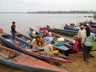 Villagers prepare for their day on beached boats.