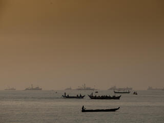 Fishermen on artisanal fishing boats, out at sea, Tema, Ghana.