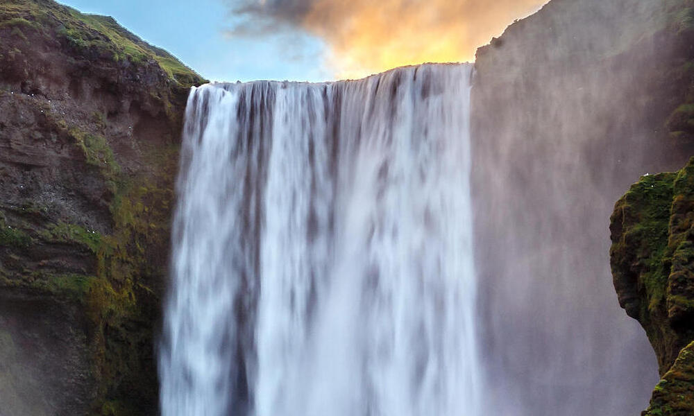 Green cliffs with a waterfall