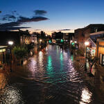 a flooded city street at sunset