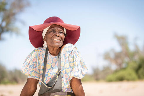 Rebecca Adams sits outside De Riet village, Namibia