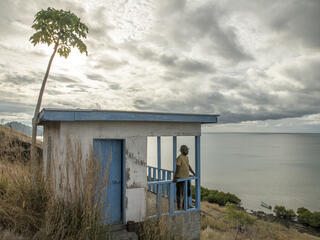 Henry R. Kolinirai, a turtle monitor representative of the Nakawaga village, overlooks the bay from the WWF-funded guard house on northern Mali Island.