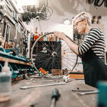 A person working on a bicycle wheel