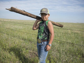 Boy repairing fences